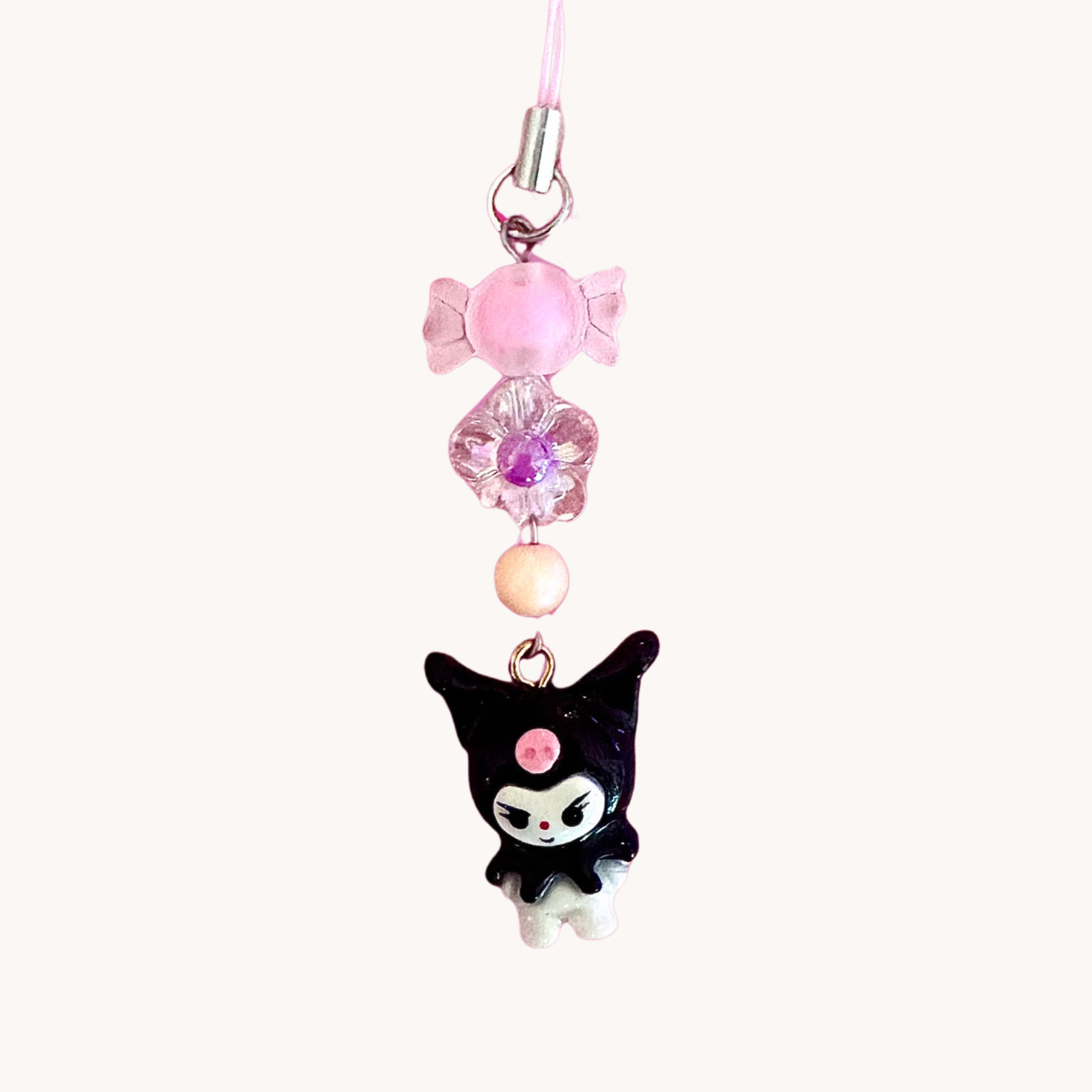 handmade kuromi polymer clay charm with pink beads on a white background