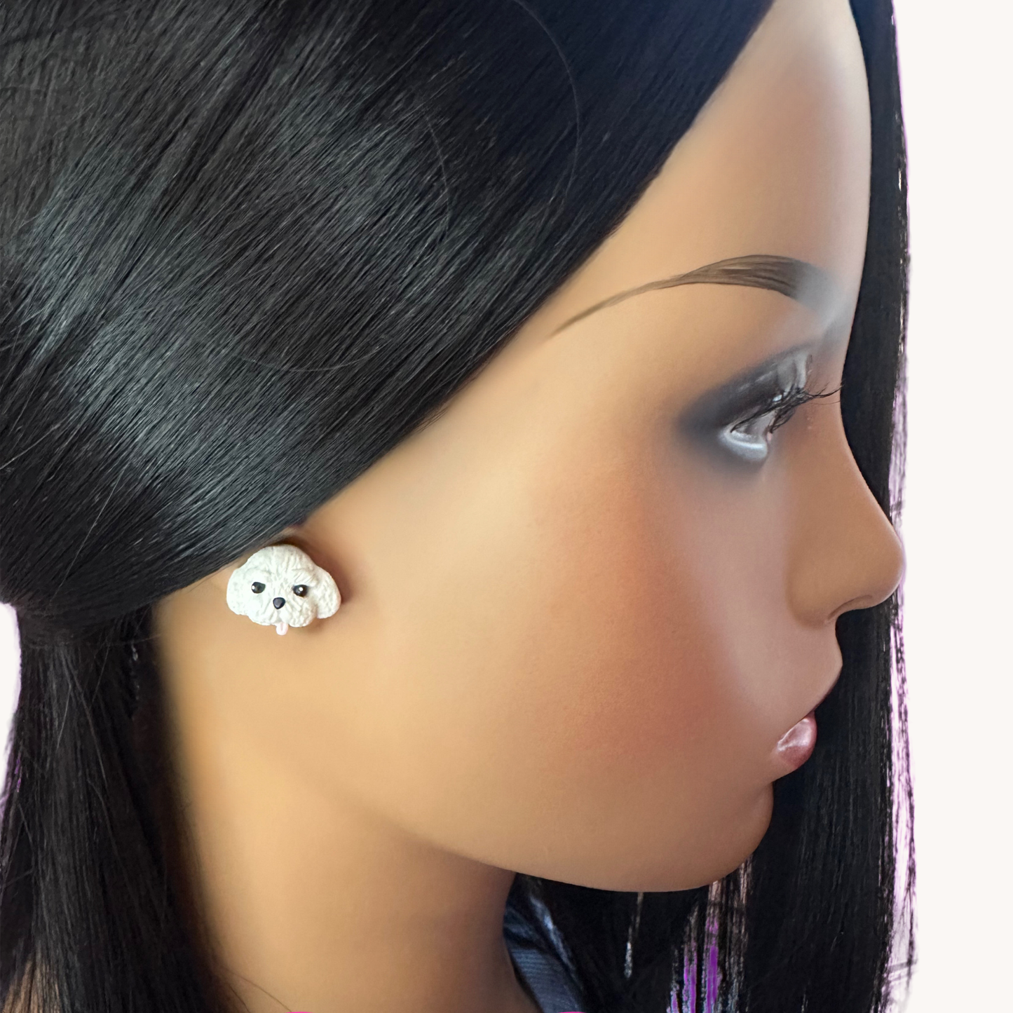 handmade polymer clay poodle stud earrings on a model