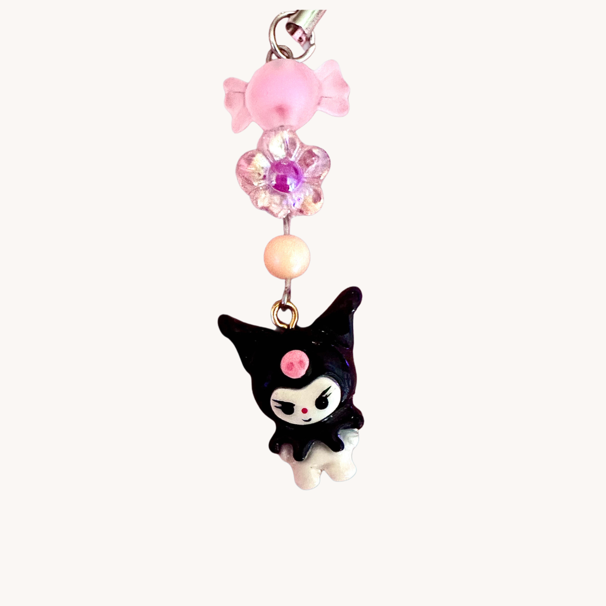 handmade kuromi polymer clay charm with pink beads on a white background