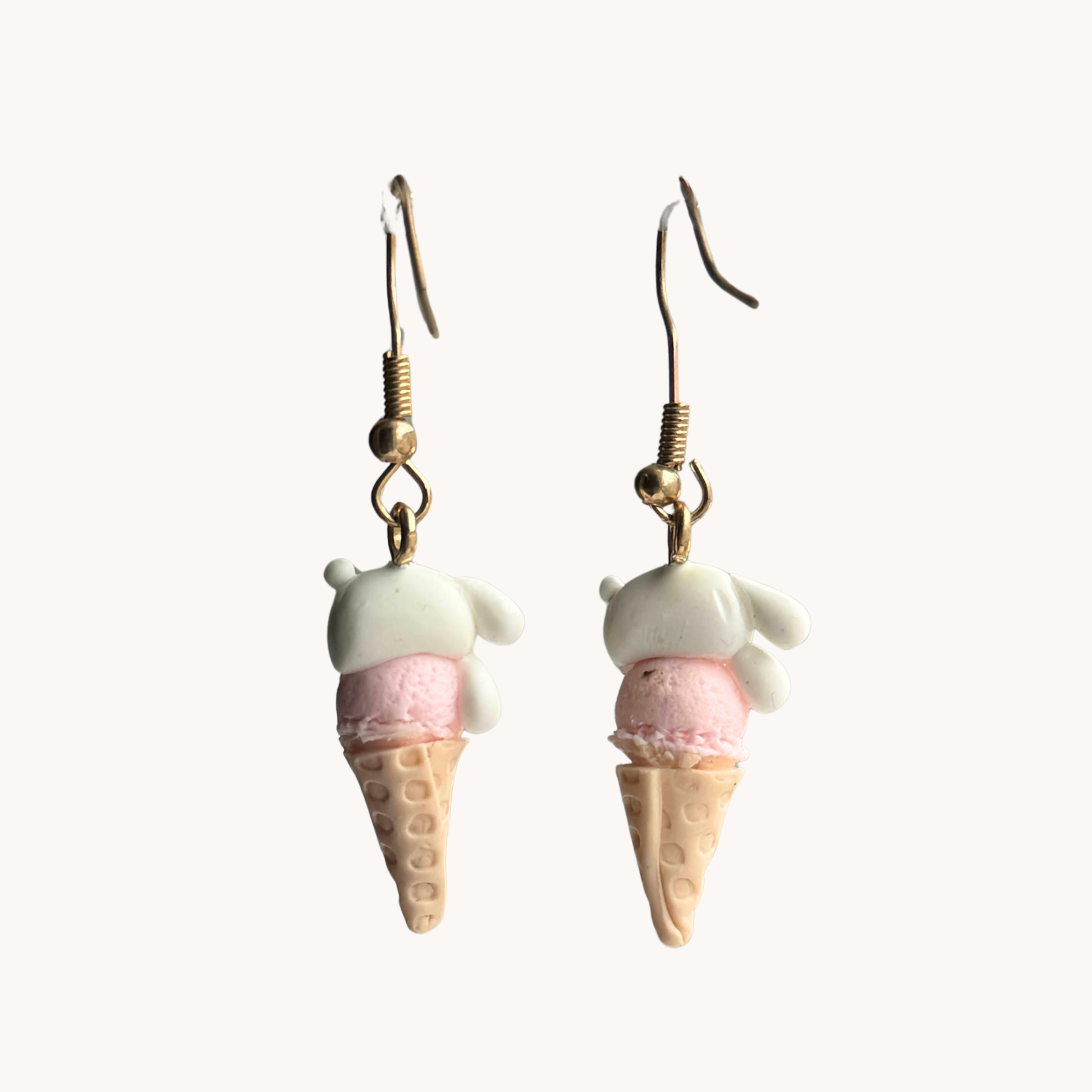 Ice cream cone earrings with pink and bunny tops on a white background