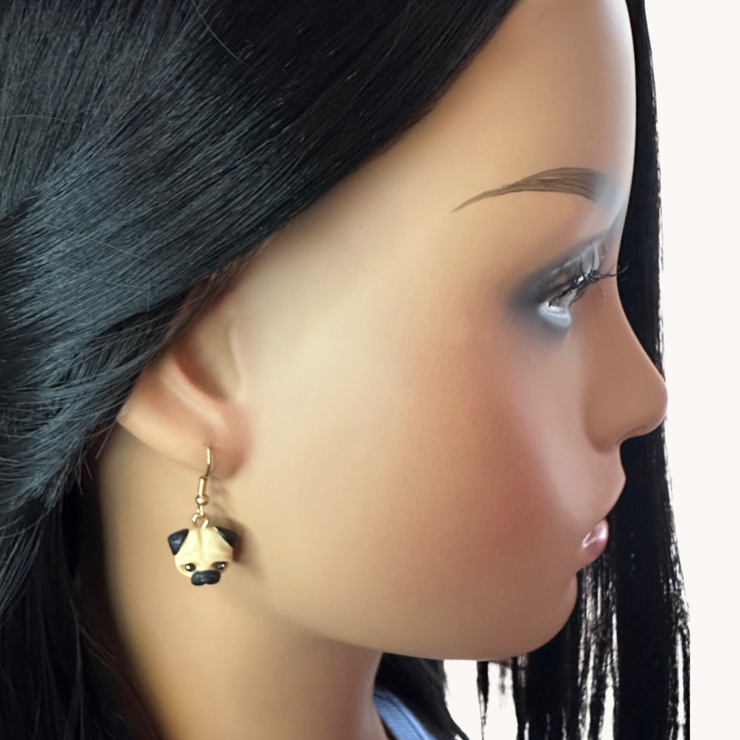 handmade polymer clay pug earrings on gold toned hooks on model