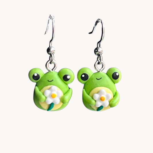 cute polymer clay green frog holding a daisy dangle earrings